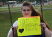 take 3 high resolution photos of my girlfriend holding a sign to promote your message small2