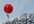 write a message on a tag on a latex helium filled balloon and release it, with photographic evidence which I will send to you