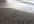 write your name/business name/message in the sand, at a black sand beach and photograph it