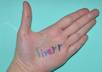 write any name or word on the palm of my hand with colorful aquarelle